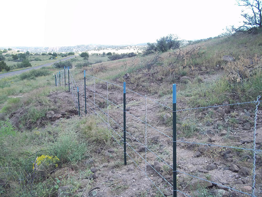 Livestock and ranch fence installed across rugged Arizona terrain